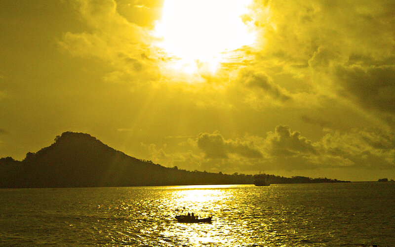 Silhouetted Boat on Water — Yellow, Dramatic