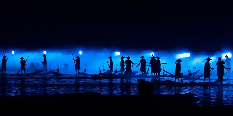 Silhouetted Boat Performers — Blue