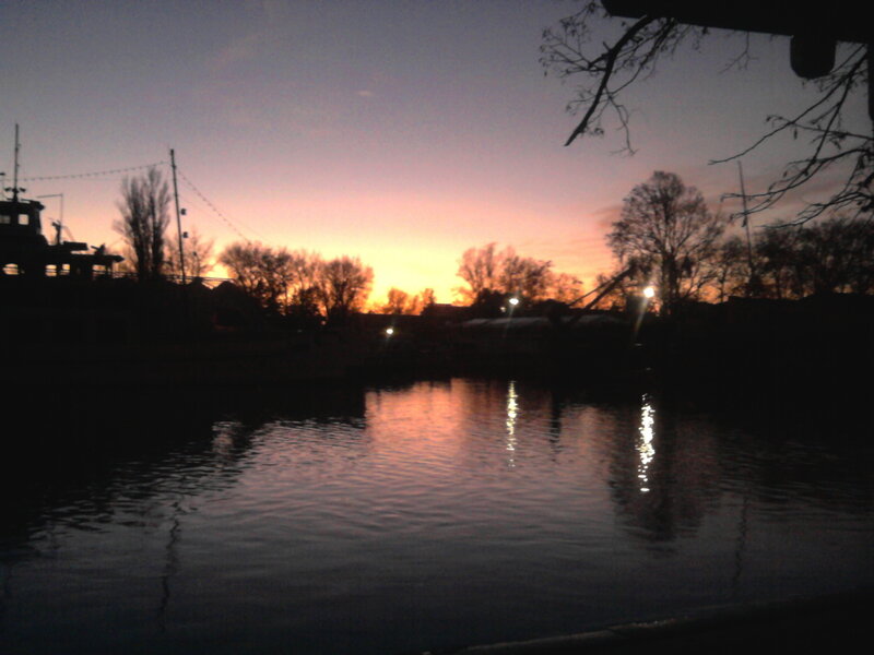 Silhouetted Boats at Dusk — Orange
