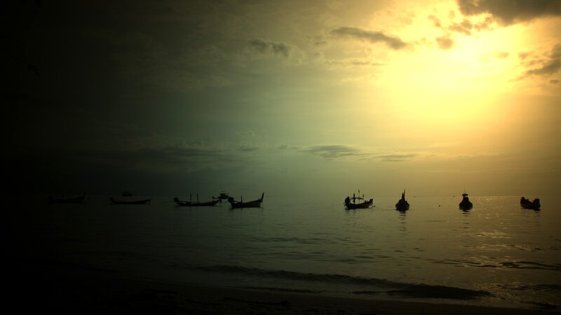 Silhouetted Boats at Sea