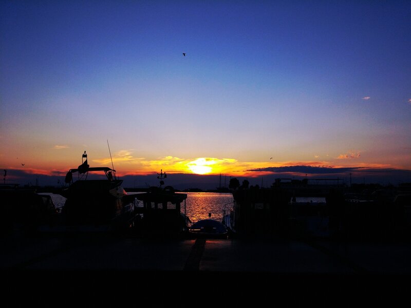 Silhouetted Boats at Sunset — Blue