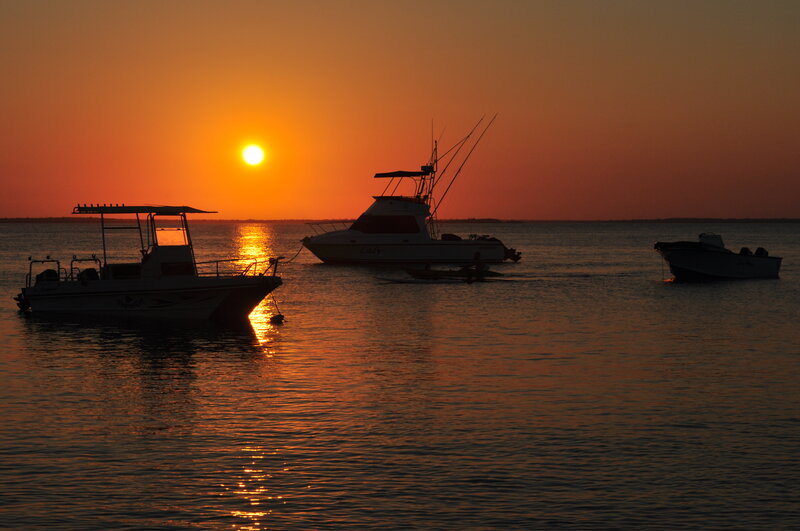 Silhouetted Boats at Sunset — Orange, Serene, Photograph, Sun, Water