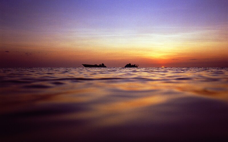 Silhouetted Boats at Sunset — Purple