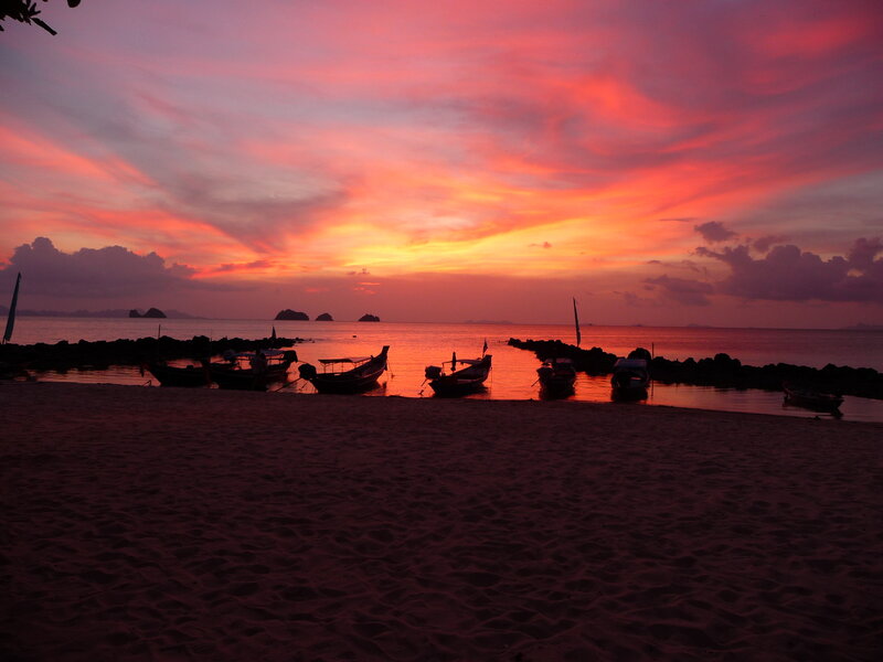 Silhouetted Boats at Sunset — Red