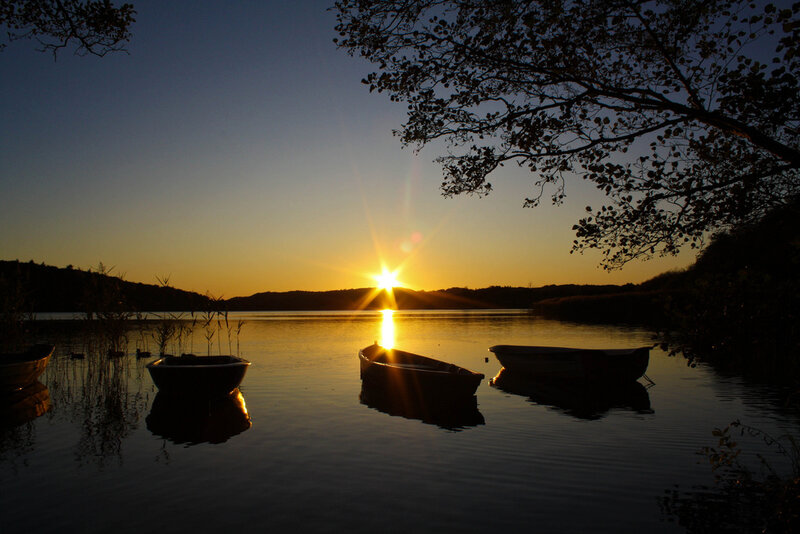 Silhouetted Boats at Sunset — Yellow