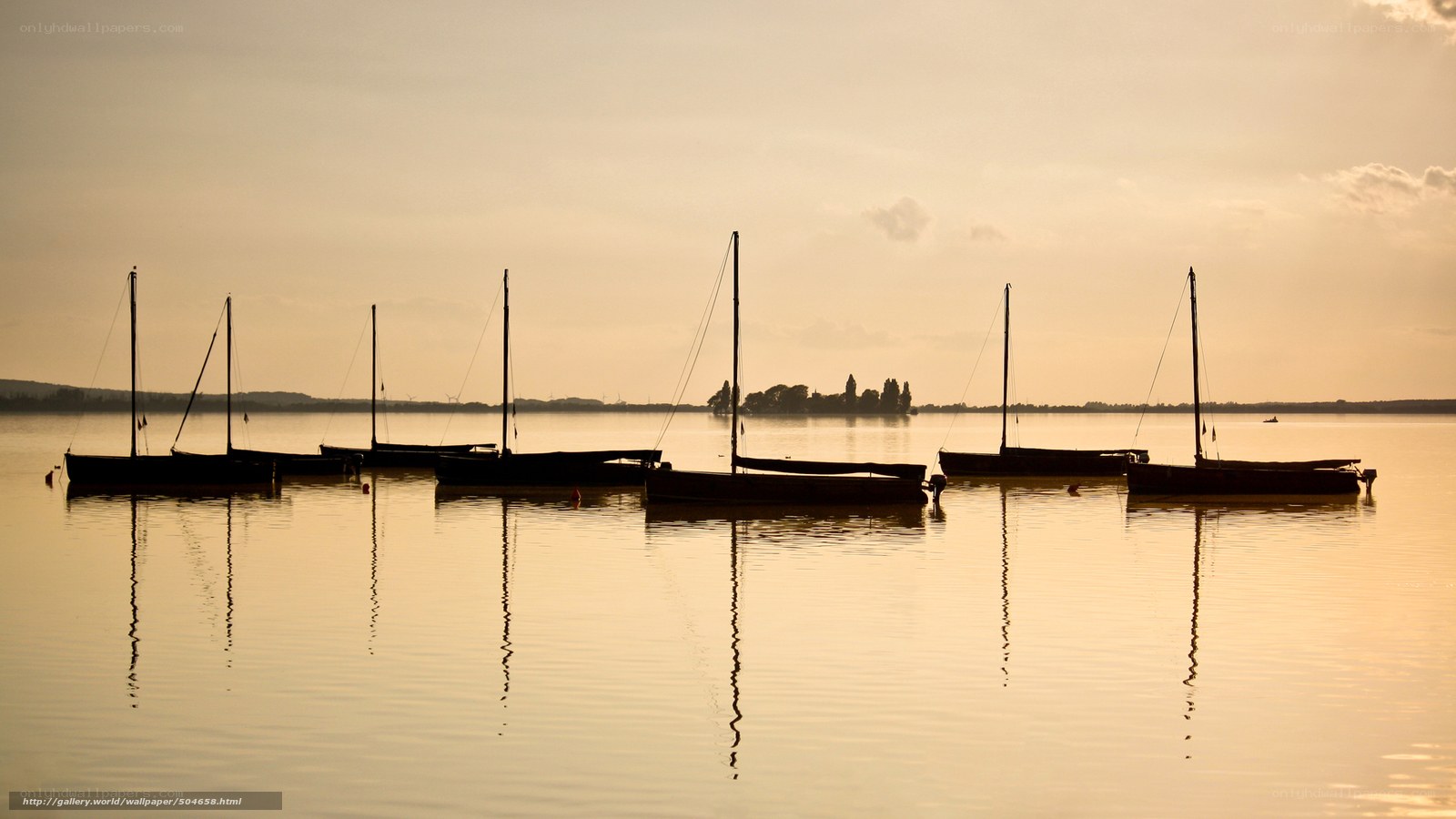 Silhouetted boats at sunset