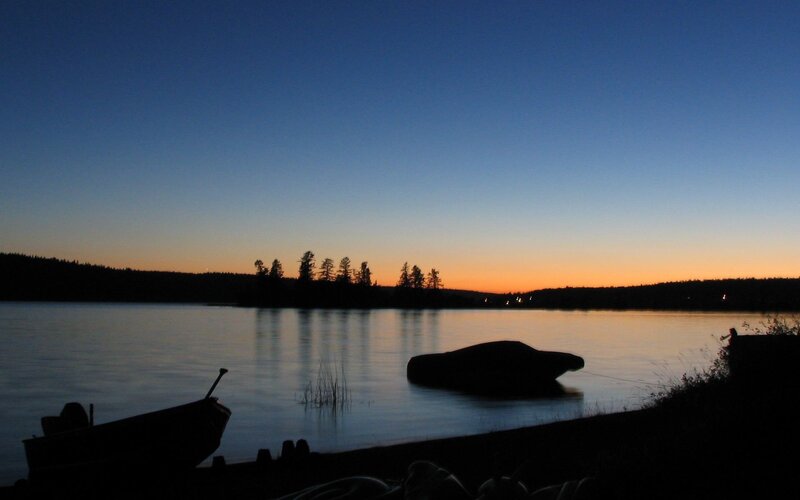Silhouetted Boats on Lake — Blue, Serene, Sunset