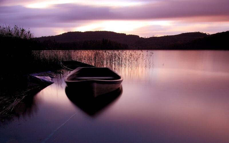 Silhouetted Boats on Lake