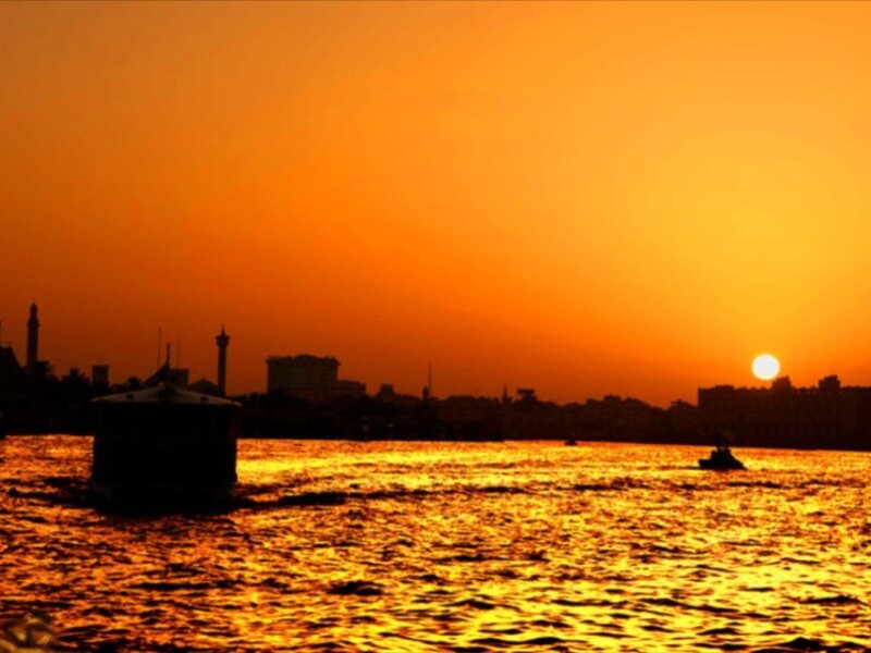 Silhouetted Boats on River — Orange, Serene