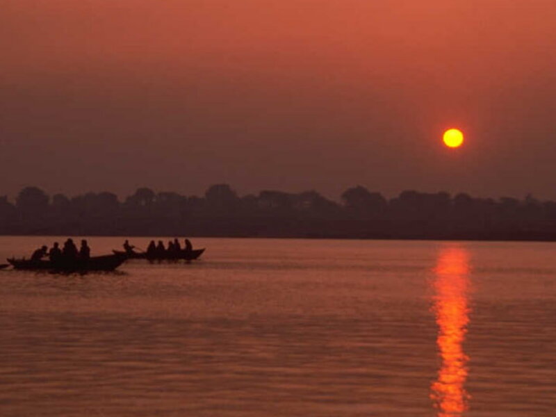 Silhouetted Boats on River — Orange