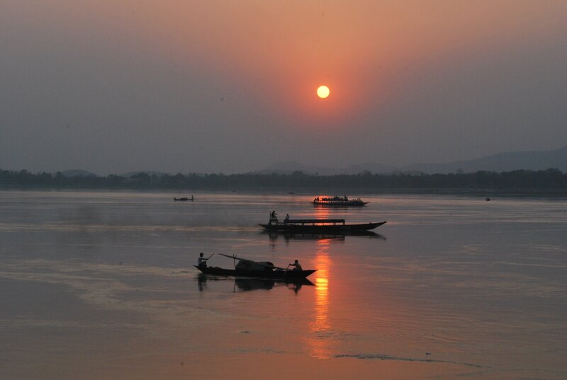 Silhouetted Boats on River