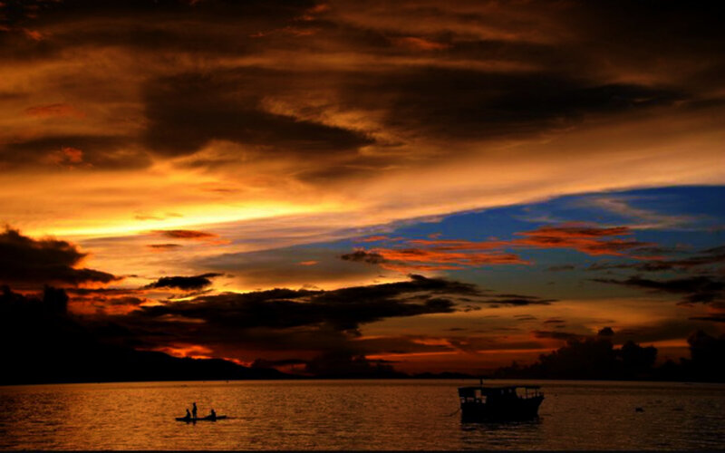 Silhouetted Boats on Water — Orange, Dramatic