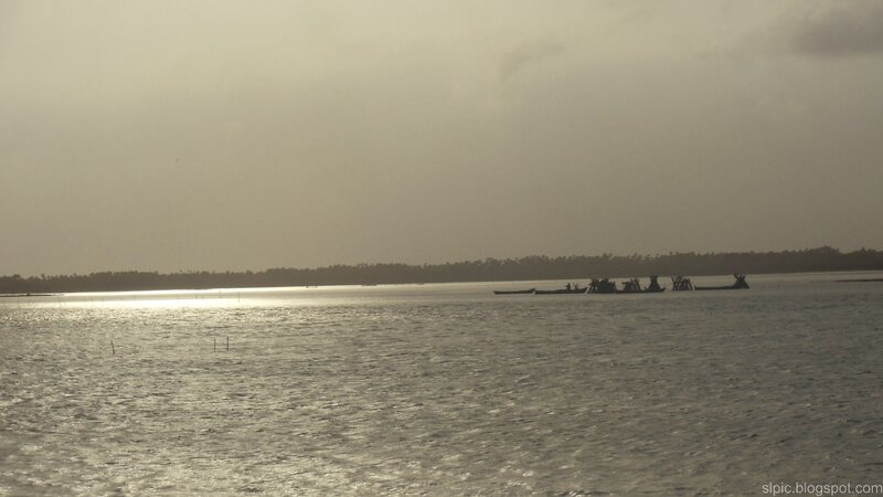 silhouetted boats on water