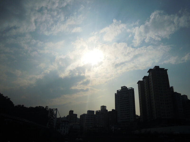 Silhouetted Buildings and Sun