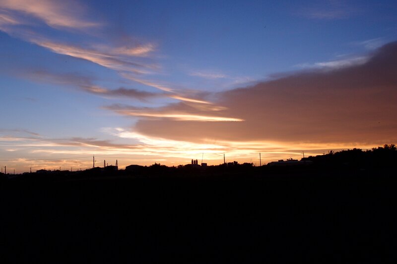Silhouetted Buildings at Sunset — Blue, Serene, Photograph, Clouds