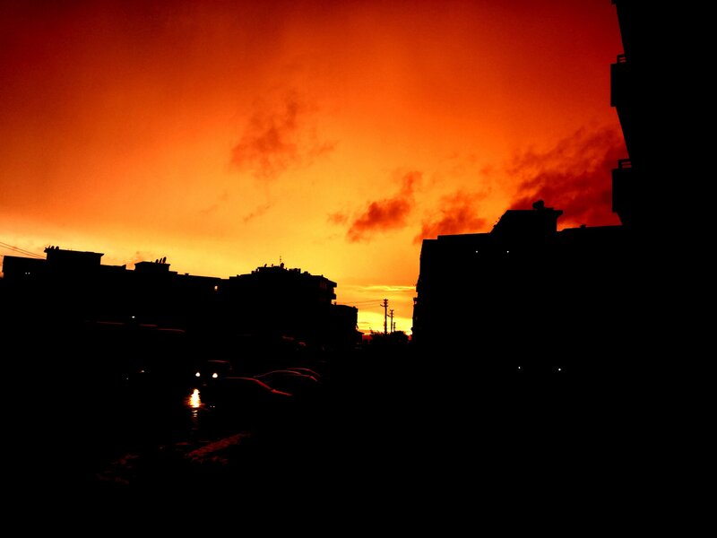 Silhouetted Buildings at Sunset — Orange, Dramatic, Photograph, Cars
