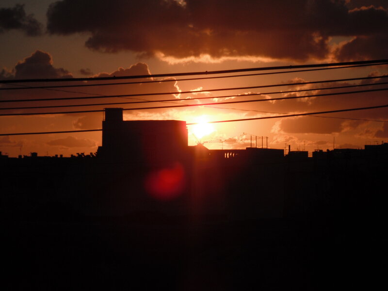 Silhouetted Buildings at Sunset — Orange, Dramatic, Photograph