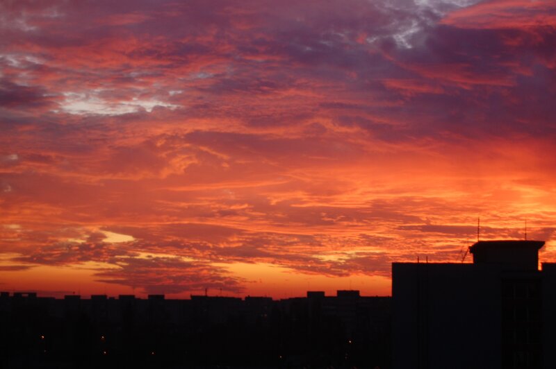 Silhouetted Buildings at Sunset — Orange