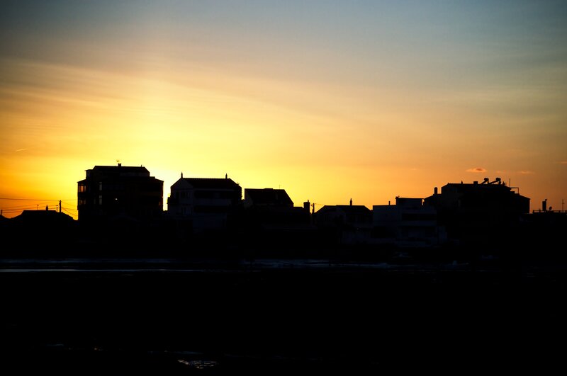 Silhouetted Buildings at Sunset — Yellow