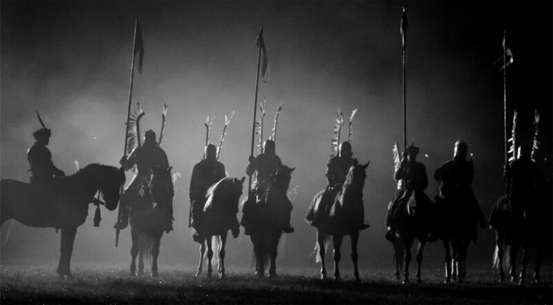 Silhouetted cavalry in mist