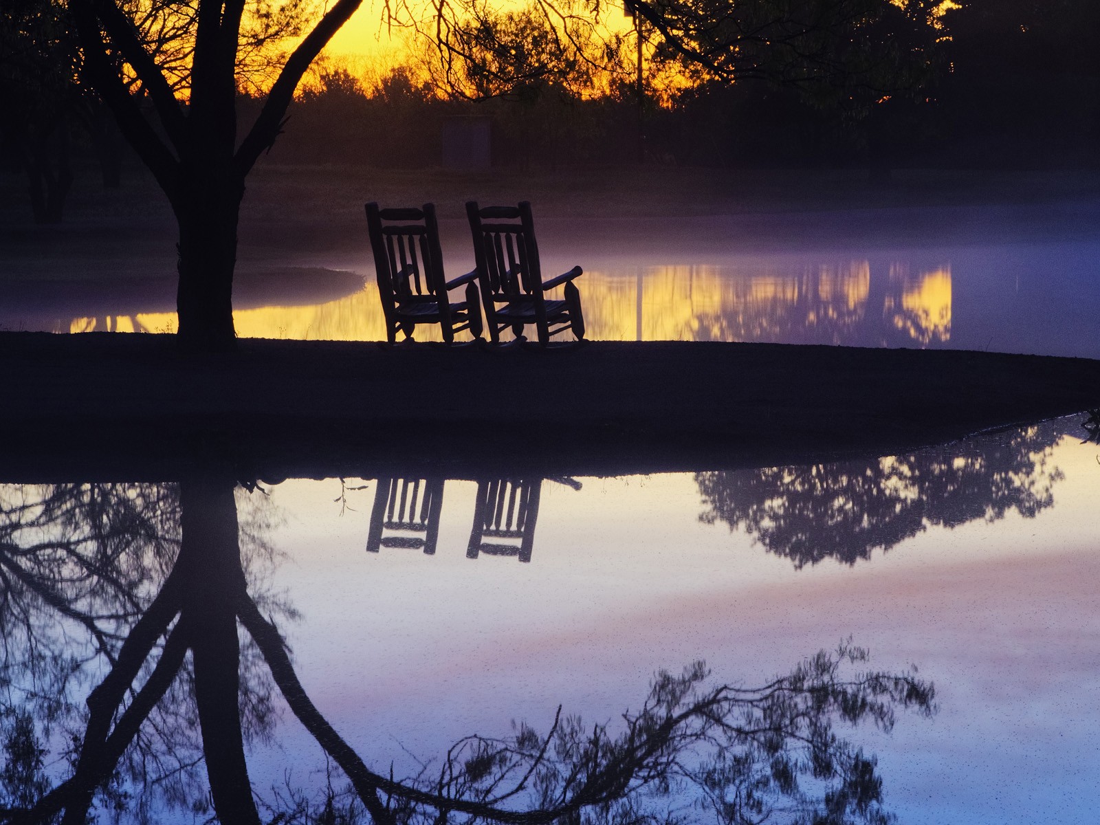 Silhouetted chairs at sunset