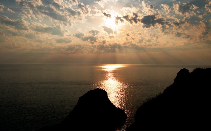 Silhouetted Cliffs at Sunset — Gold, Serene