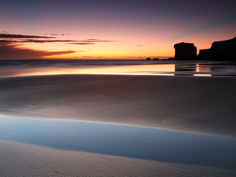 Silhouetted Cliffs at Sunset — Orange, Serene, Photograph, Ocean