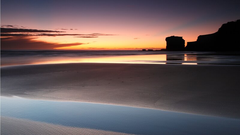 Silhouetted Cliffs at Sunset — Orange, Serene