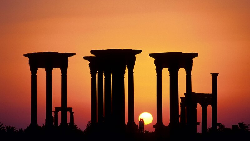 Silhouetted Columns at Sunset — Orange, Dramatic, Photograph, Sun, People