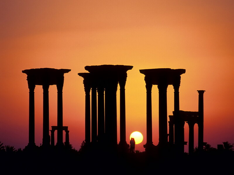 Silhouetted Columns at Sunset — Orange, Dramatic, Photograph, Sun