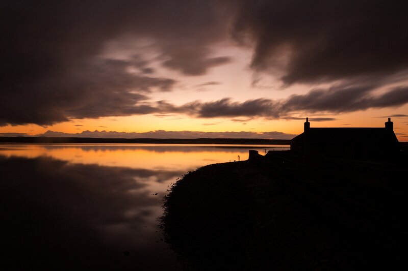 Silhouetted Cottage at Sunset