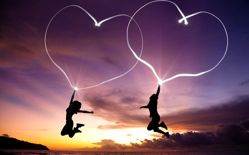 Silhouetted Couple Jumping