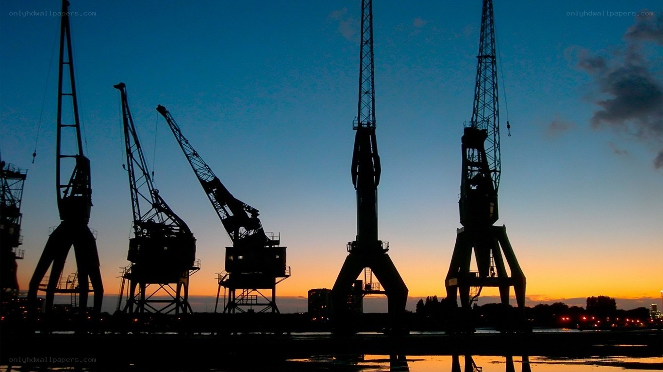silhouetted cranes at sunset