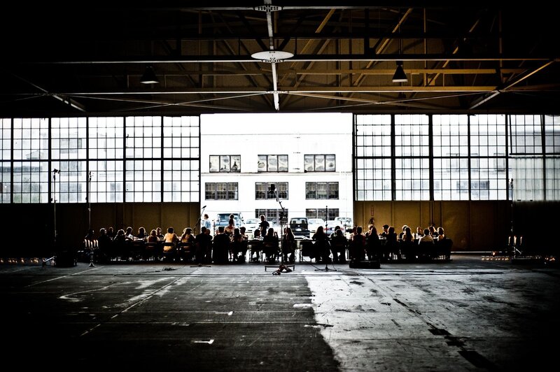Silhouetted dinner in a warehouse