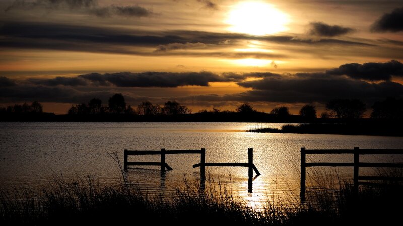 Silhouetted Fence in Water