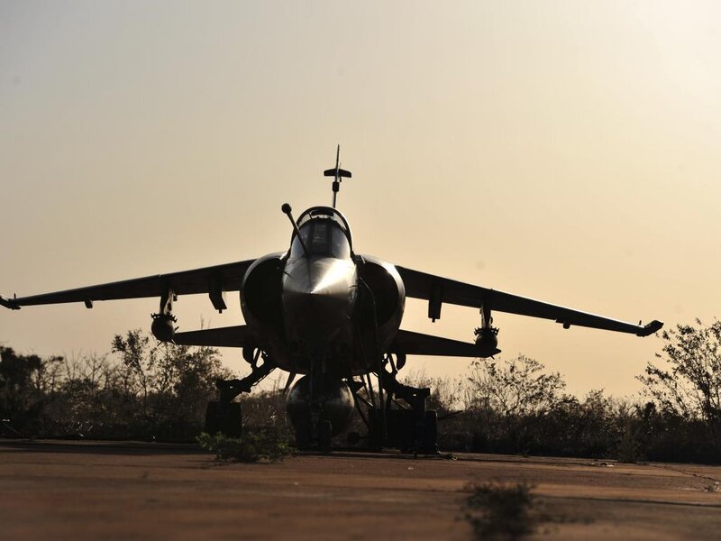 Silhouetted Fighter Jet — Brown
