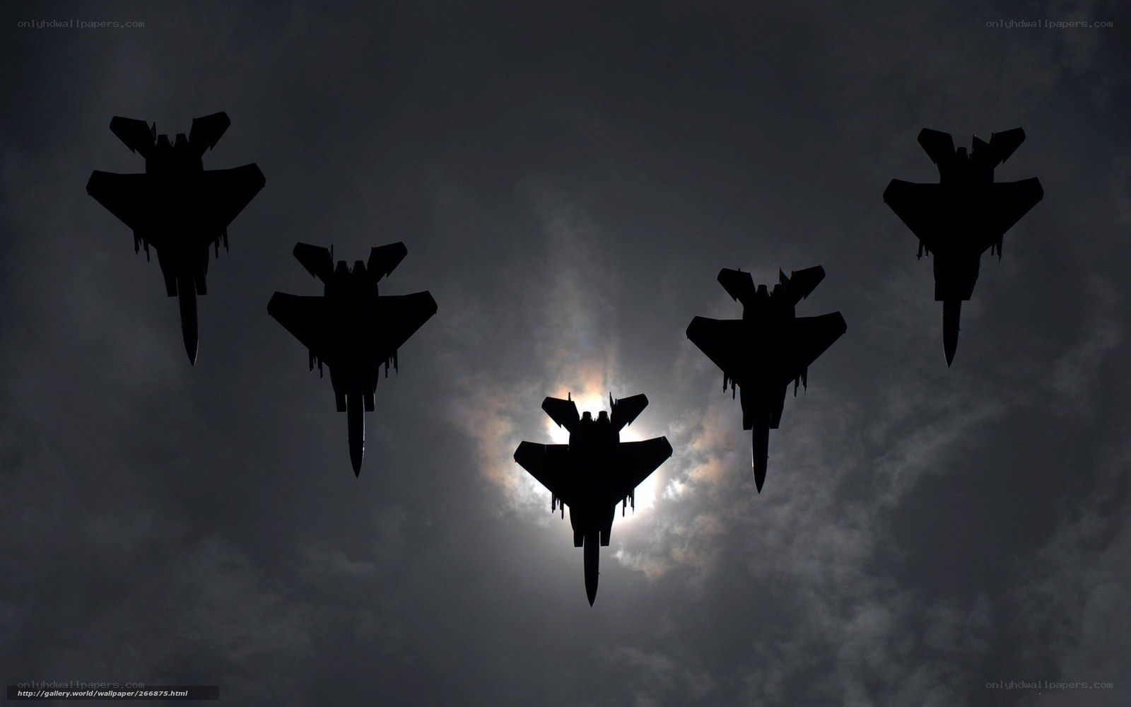 Silhouetted fighter jets in formation