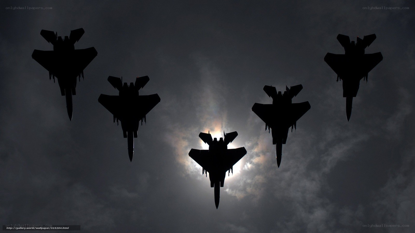Silhouetted fighter jets in formation