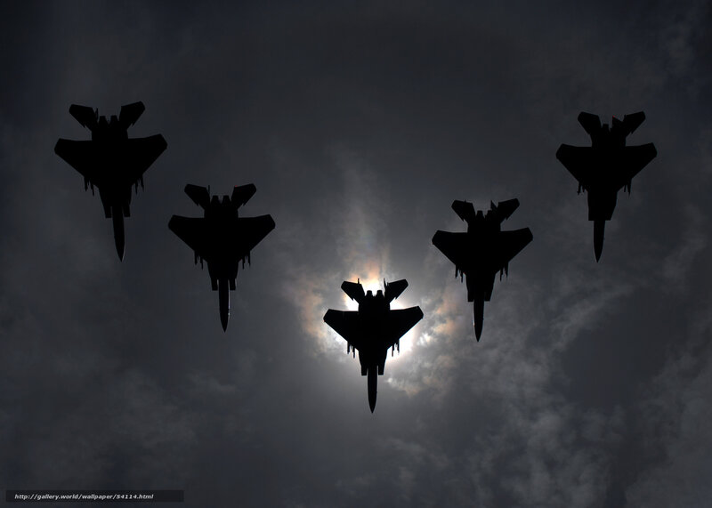 Silhouetted fighter jets in formation