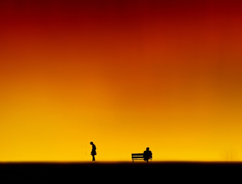 Silhouetted Figures at Sunset — Red