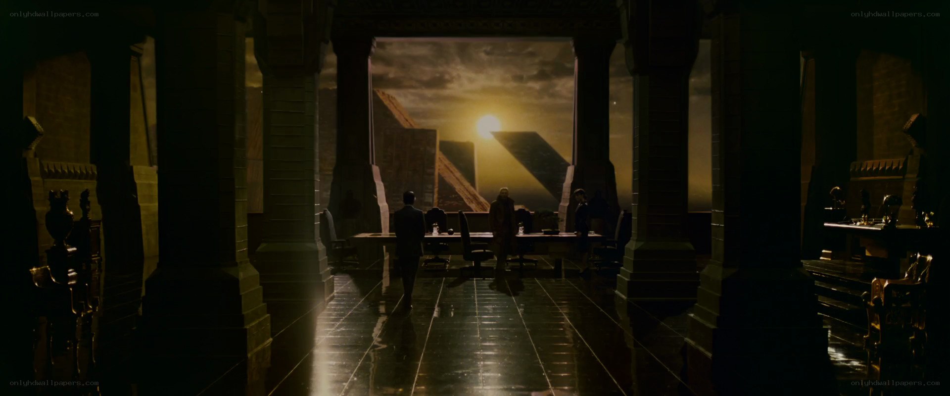 Silhouetted figures in grand hall