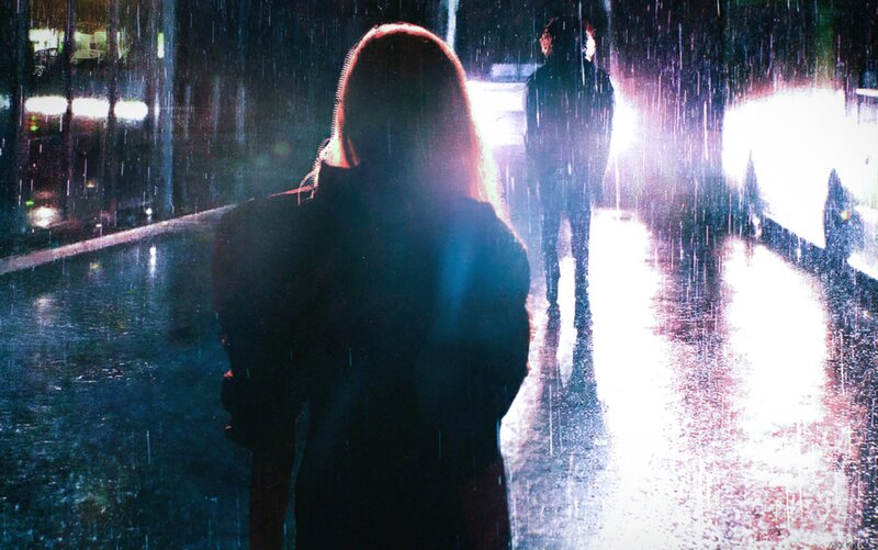 Silhouetted Figures in Rain
