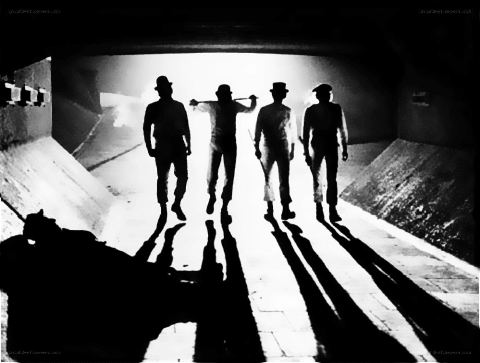 Silhouetted figures in tunnel