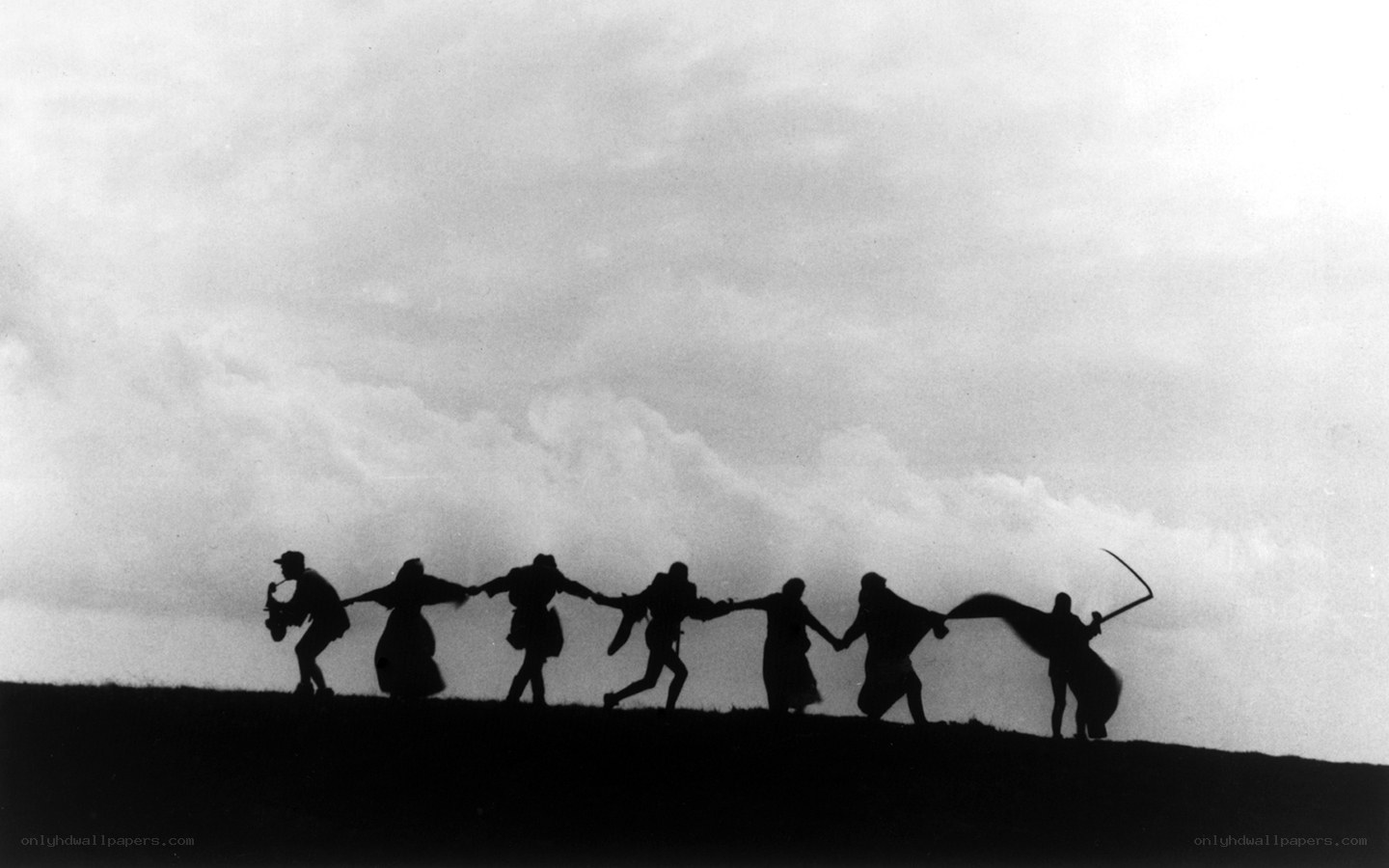Silhouetted figures on a hill