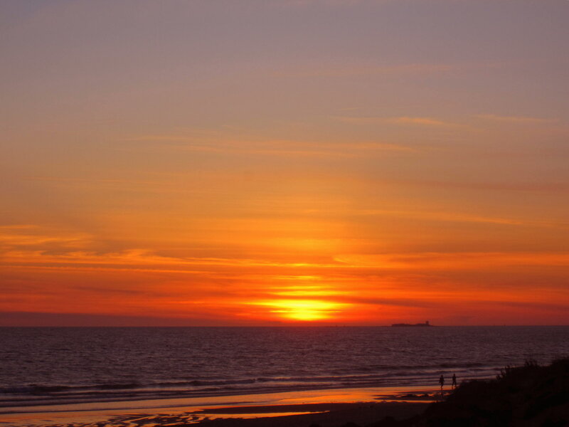 Silhouetted Figures on Beach — Orange