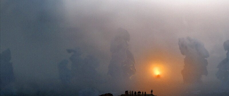 Silhouetted Figures on Cliff — Gray