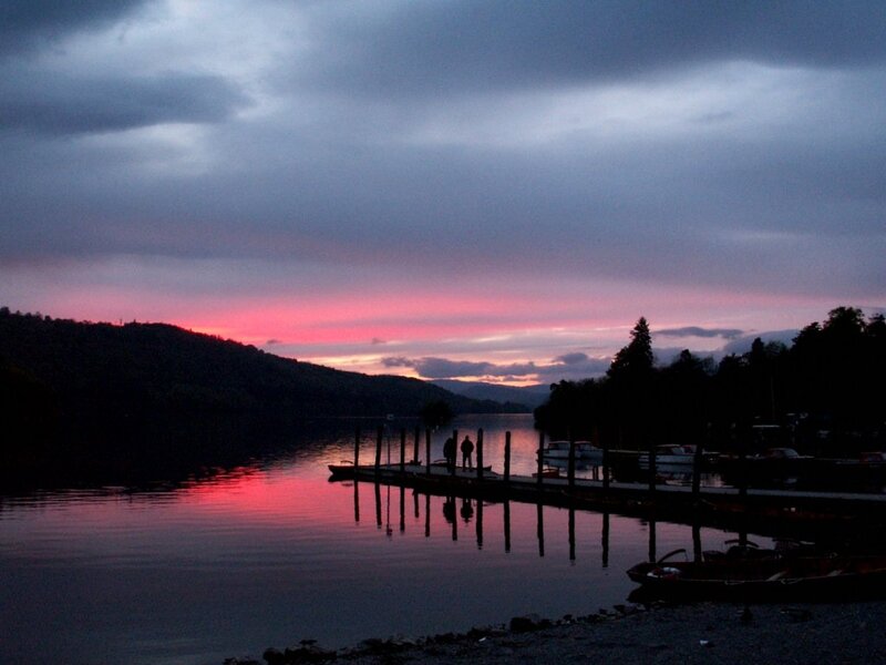 Silhouetted Figures on Dock — Pink