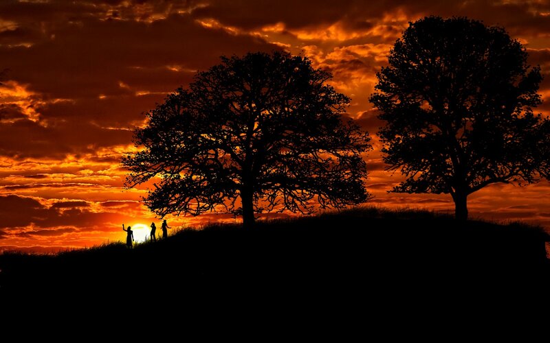 Silhouetted Figures on Hill — Orange, Dramatic