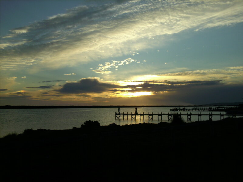 Silhouetted Figures on Pier