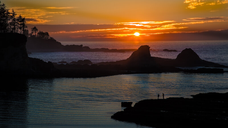 Silhouetted Figures on Rocks